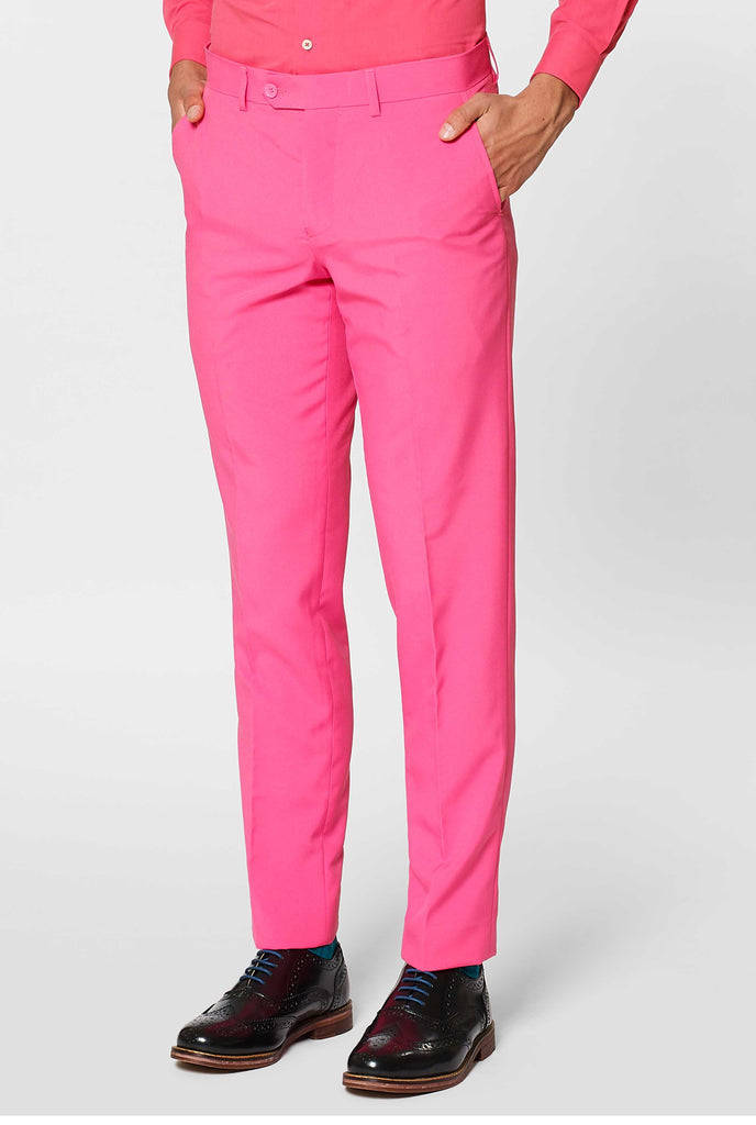 Man wearing pink men's suit with pink dress shirt, pants close up