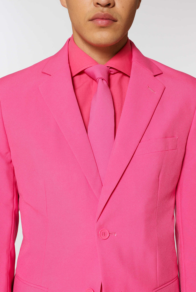 Man wearing pink men's suit with pink dress shirt, close up