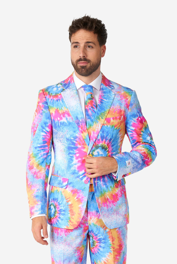 Man wearing pride men's suit with colorful tie dye rainbow print 