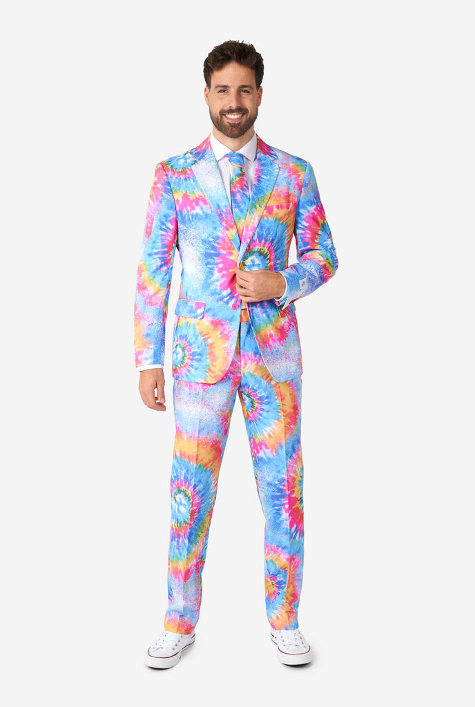 Man wearing pride men's suit with colorful tie dye rainbow print