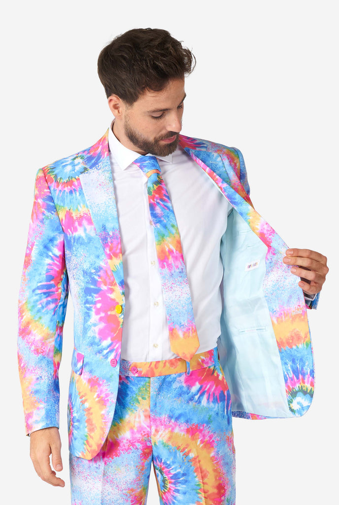 Man wearing pride men's suit with colorful tie dye rainbow print