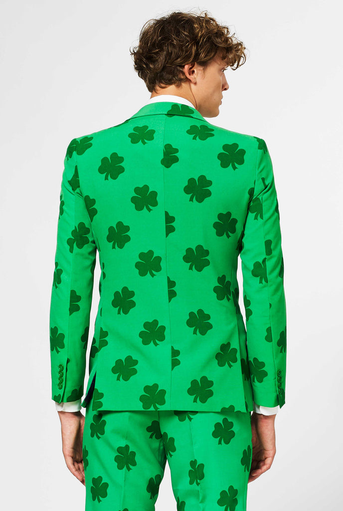 Man wearing green St. Patrick's Day men's suit, with clover print, view from the back