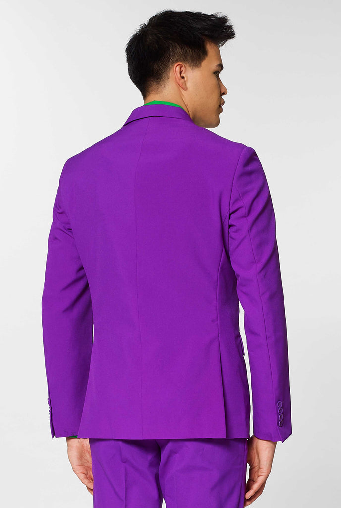 Man wearing purple men's suit and green dress shirt, view from the back