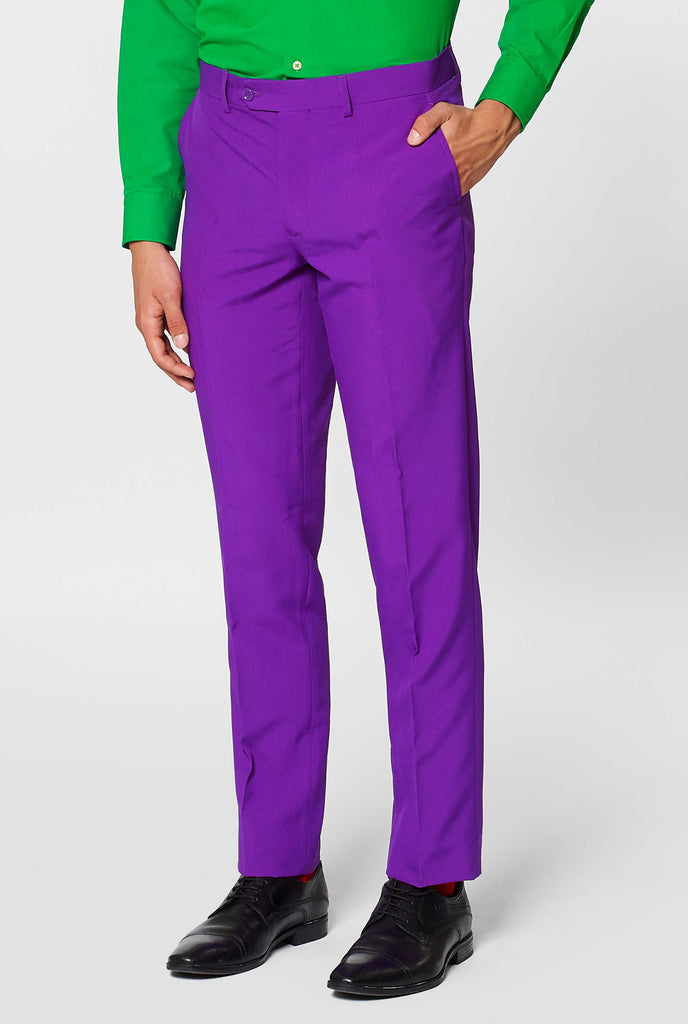 Man wearing purple men's suit and green dress shirt, pants close up