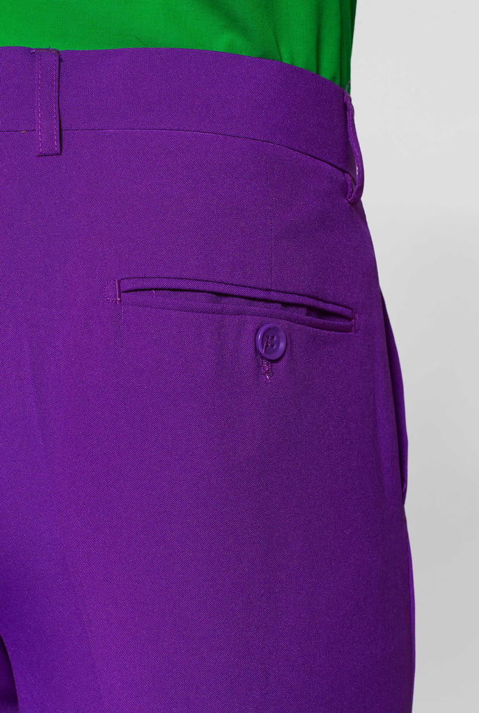 Man wearing purple men's suit and green dress shirt, pants close up