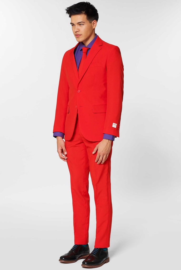 Man wearing red men's suit with purple dress shirt