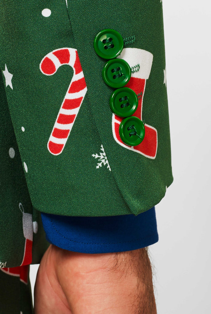 Man wearing green Christmas suit and blue dress shirt, sleeve close up