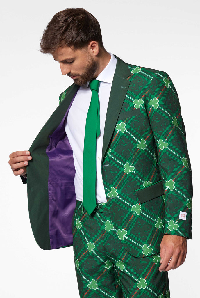 Close up of green plaid Saint Patrick's day men's suit with three-leaf-clovers worn by man showing lining