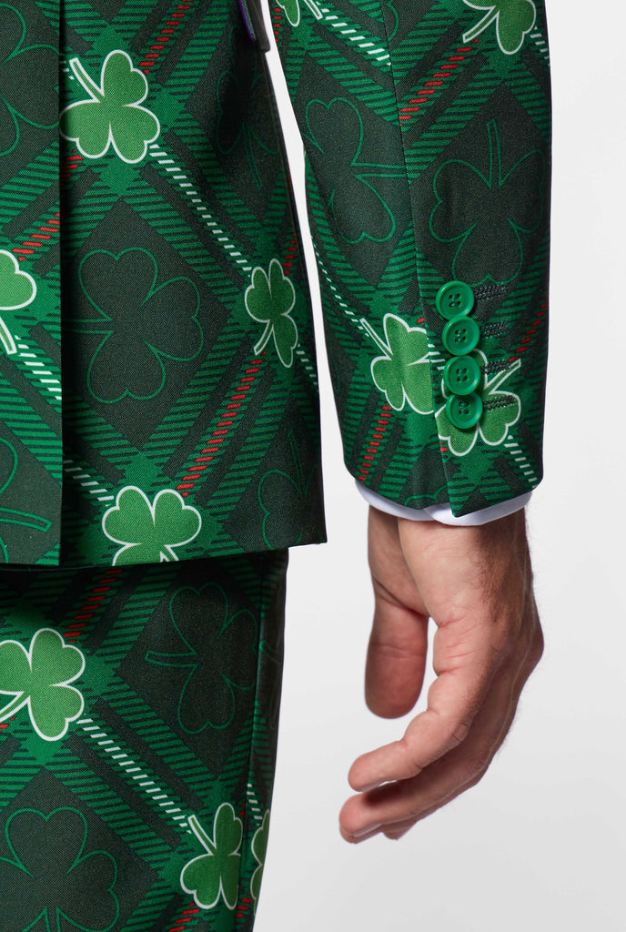 Close up up green plaid suit with three-leaf-clovers sleeve worn by man