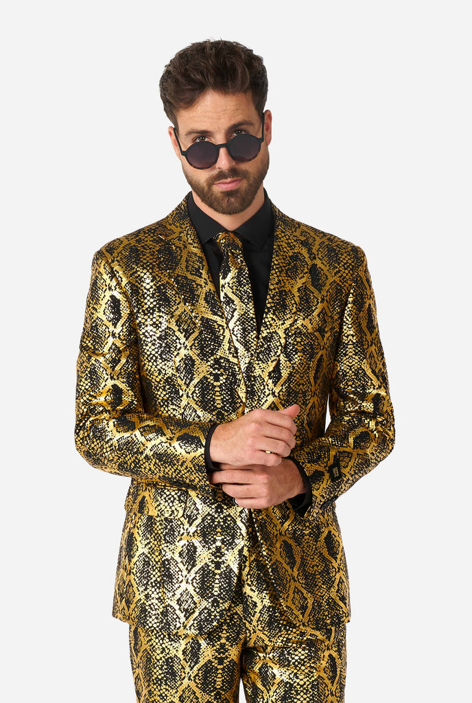 Man wearing suit with, gold and black, snakeskin print