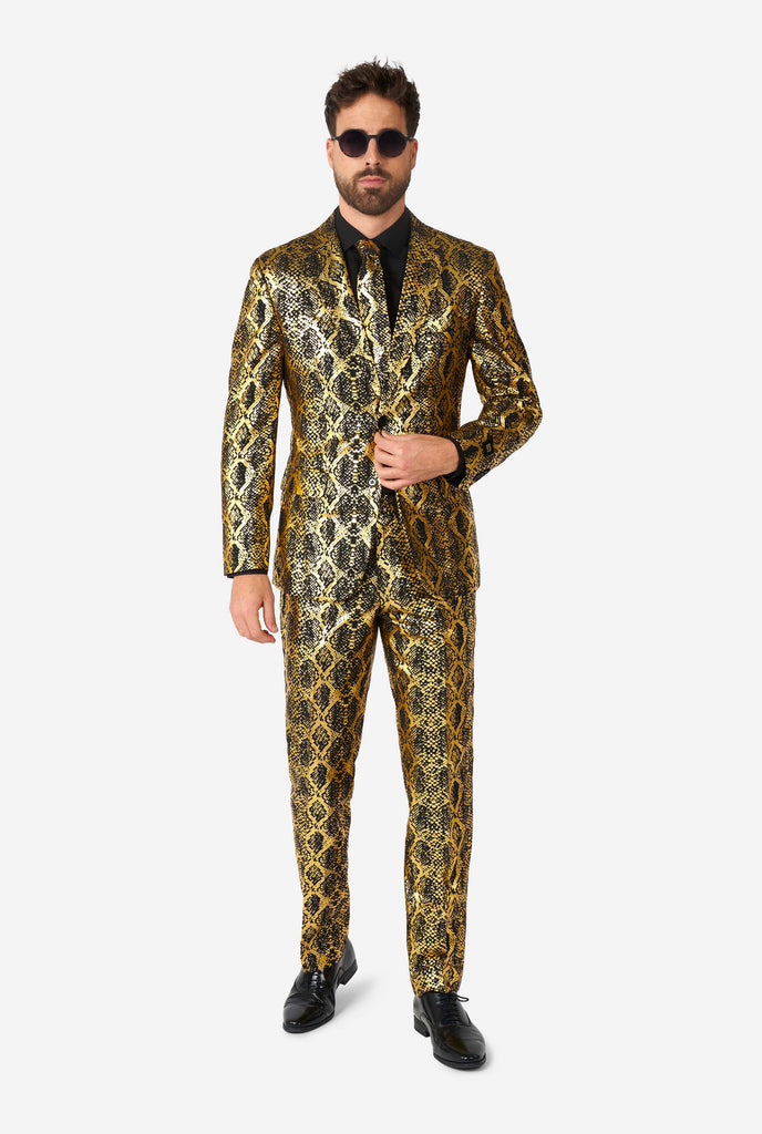 Man wearing suit with, gold and black, snakeskin print