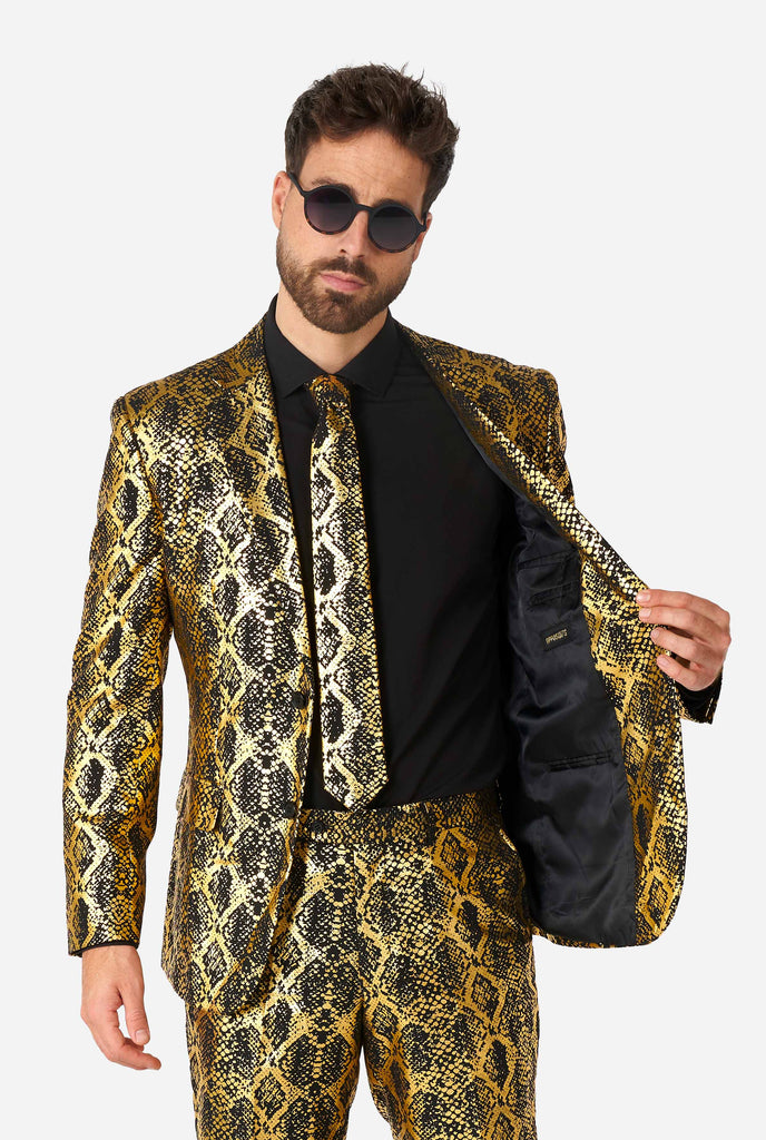 Man wearing suit with, gold and black, snakeskin print