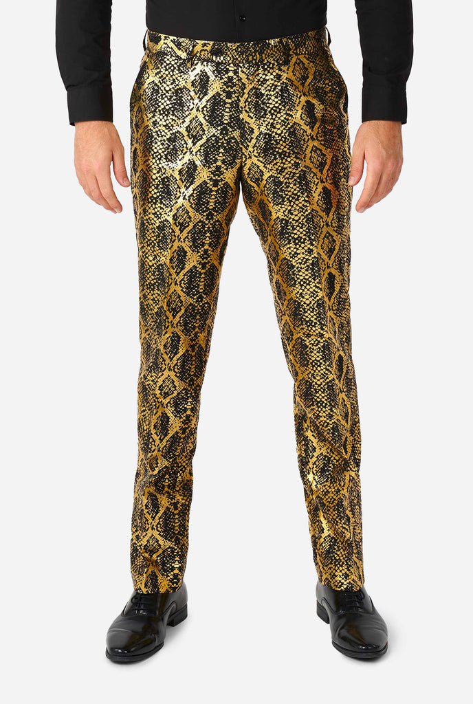 Man wearing pant with, gold and black, snakeskin print, part of the suit