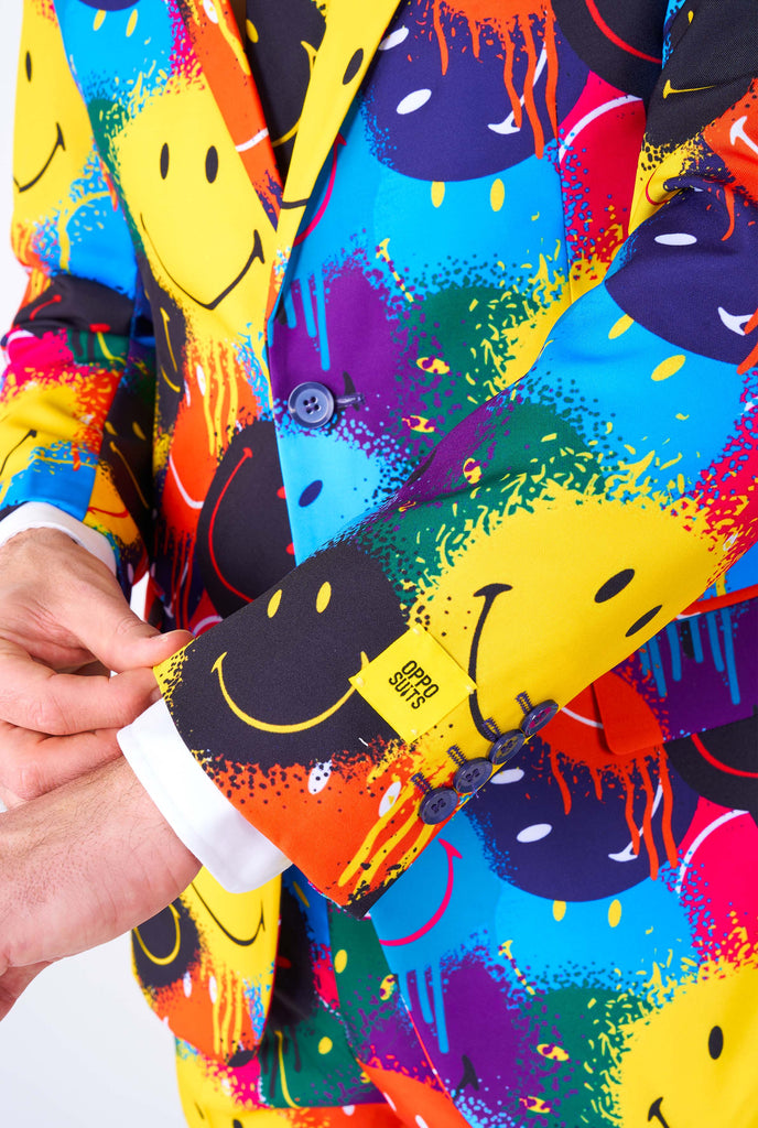 Man wearing colorful men's suit with Smiley print, close up sleeve