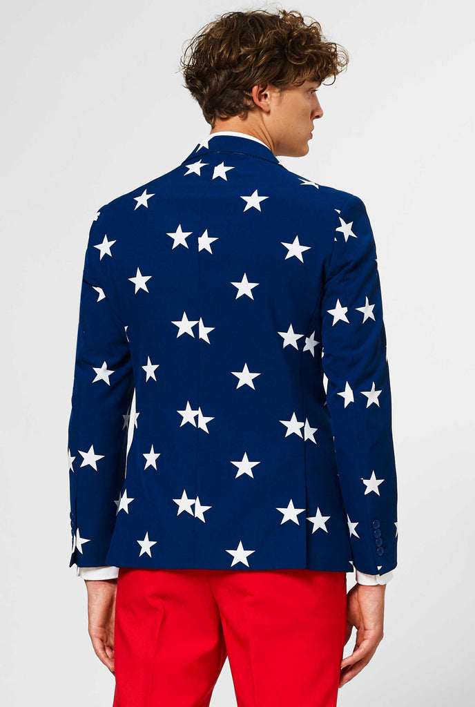 Man wearing red and blue USA themed 4th of July men's suit, view from the back