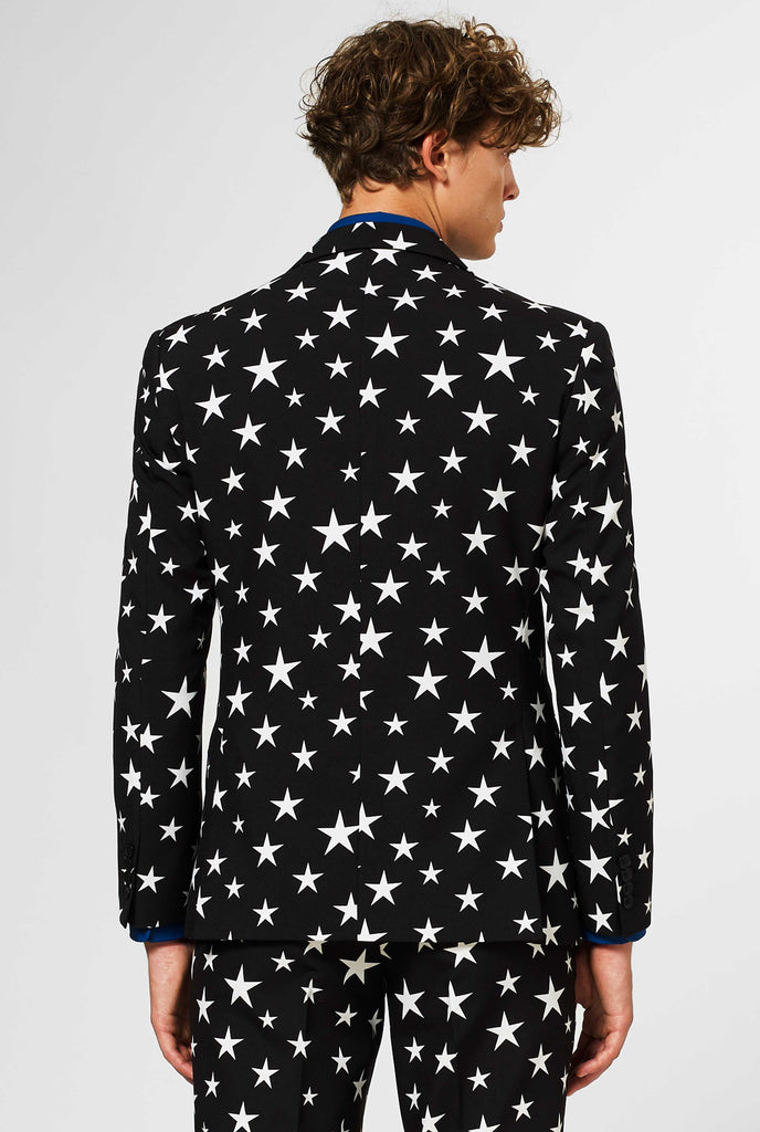 Men wearing black suit with white stars, view from the back