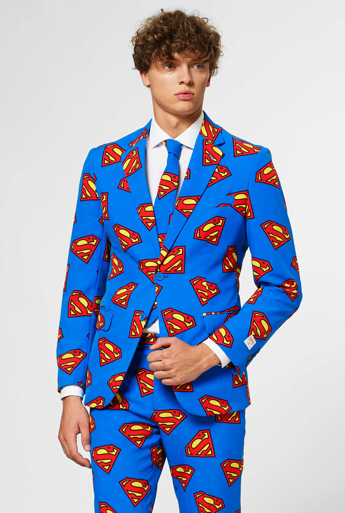 Man wearing blue men's suit with Superman logo print