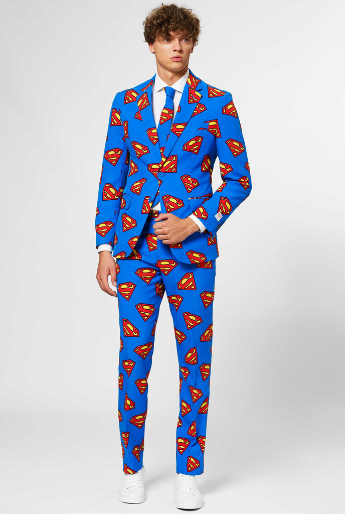 Man wearing blue men's suit with Superman logo print