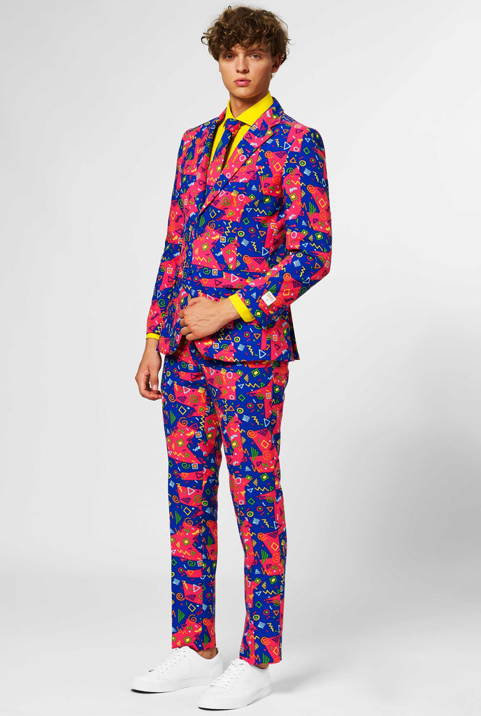 Funky pink and blue men's suit with abstract icons worn by man