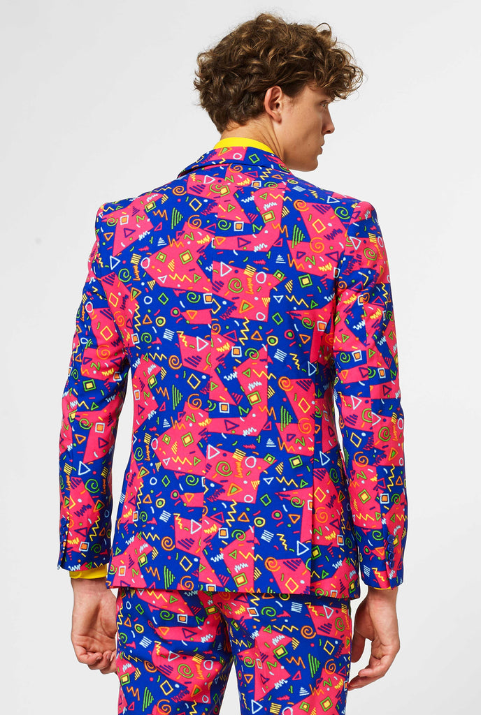 Funky pink and blue suit with abstract icons worn by man showing back