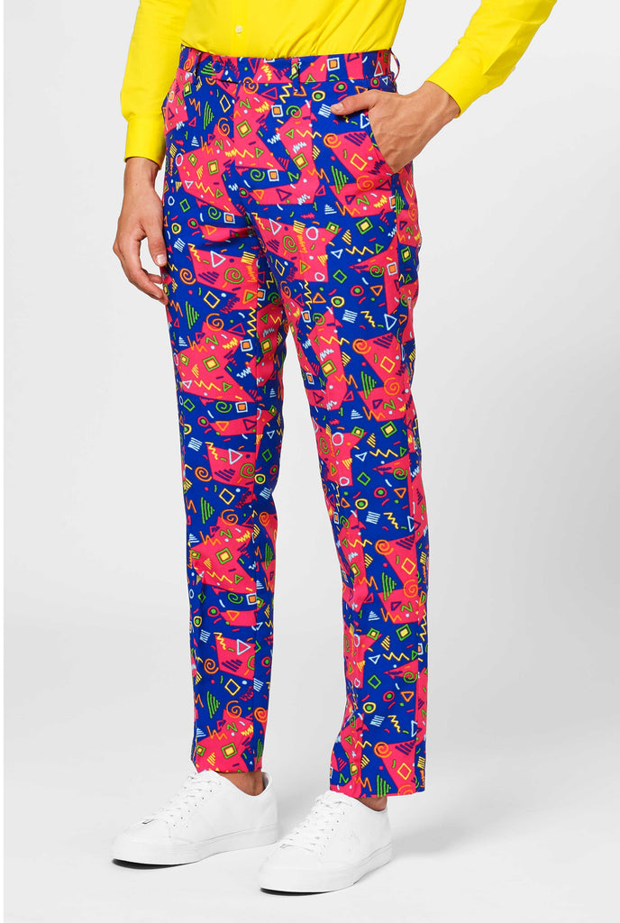 Funky pink and blue suit pants with abstract icons worn by man