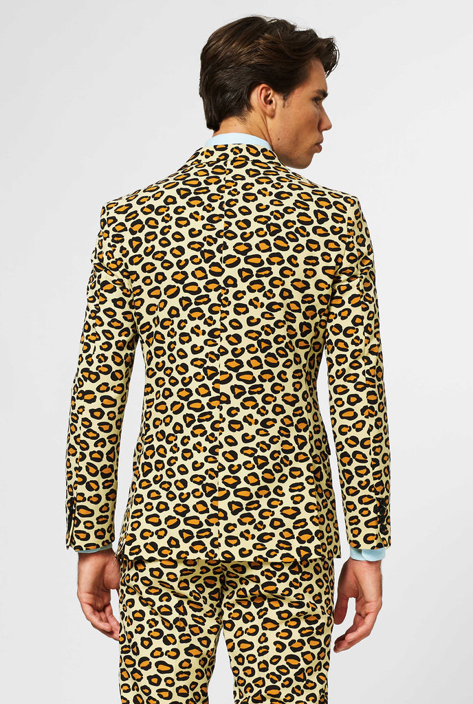 Man wearing men's suit with panther print, view from the back