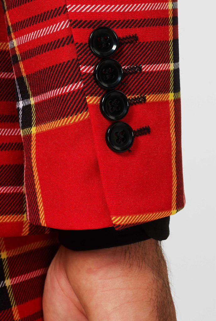 Man wearing red Christmas tartan men's suit, sleeve close up