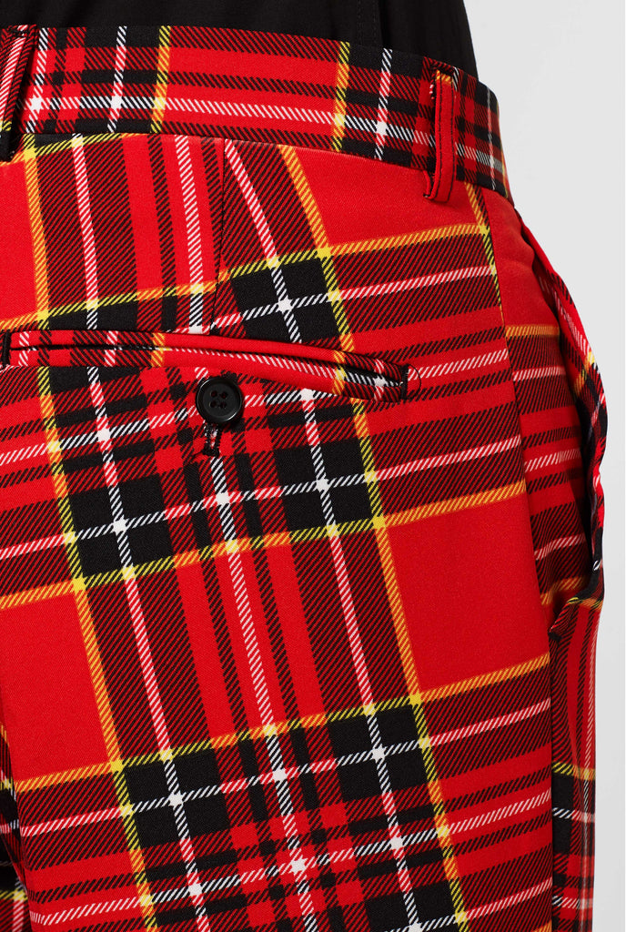 Man wearing red Christmas tartan men's suit, pants close up