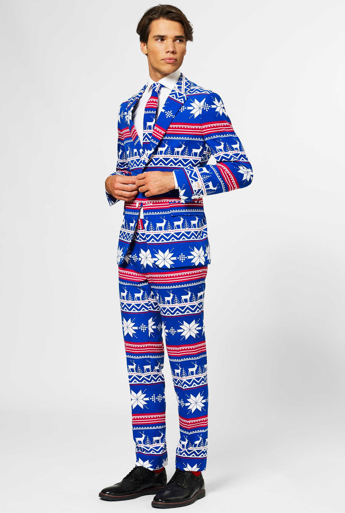 Man wearing blue Christmas suit with Nordic themed print