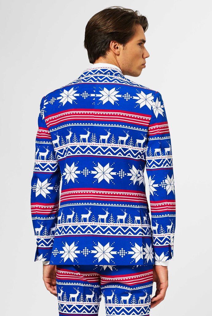 Man wearing blue Christmas suit with Nordic themed print, view from the back