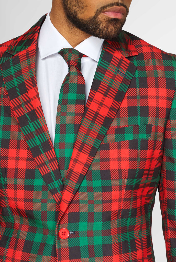 Green and red tartan Christmas men's suit worn by man