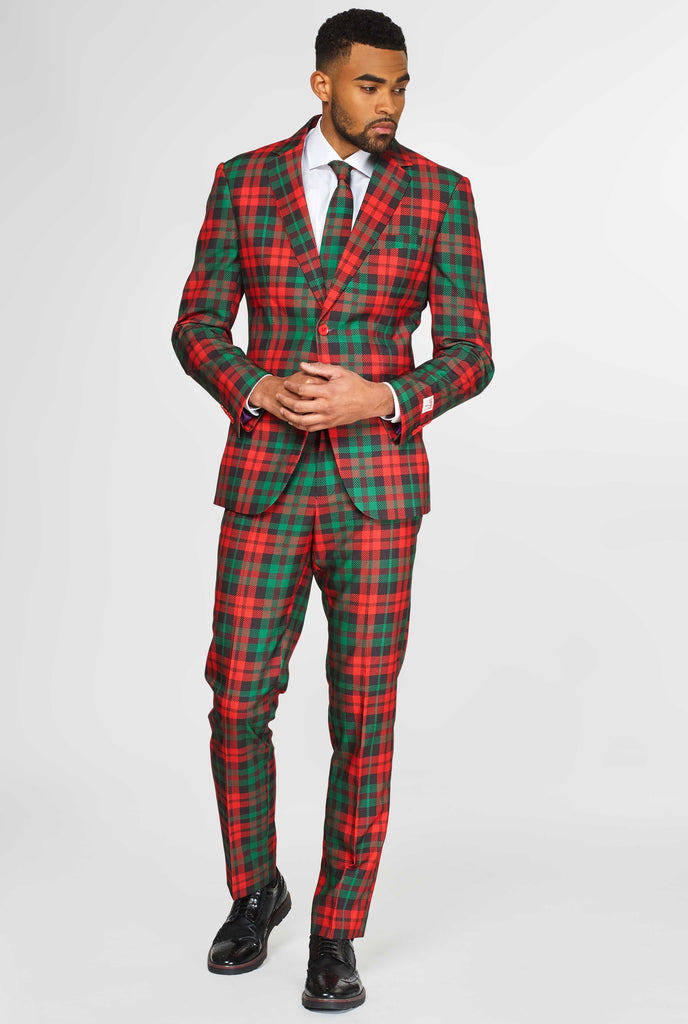 Green and red tartan Christmas men's suit worn by man