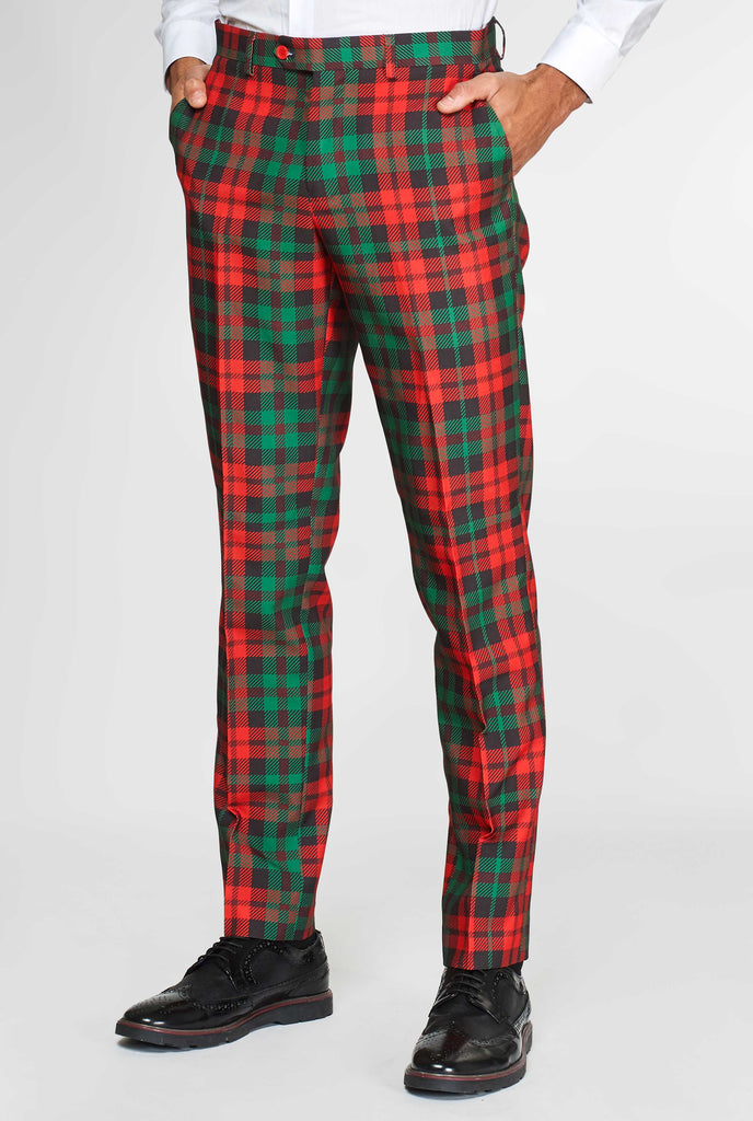 Green and red tartan suit pants worn by man