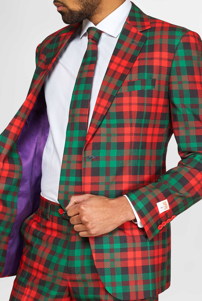 Green and red tartan suit worn by man showing inside of jacket