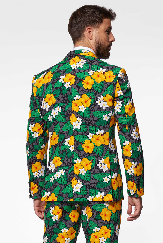 Man wearing men's suit with flower print, view from the back