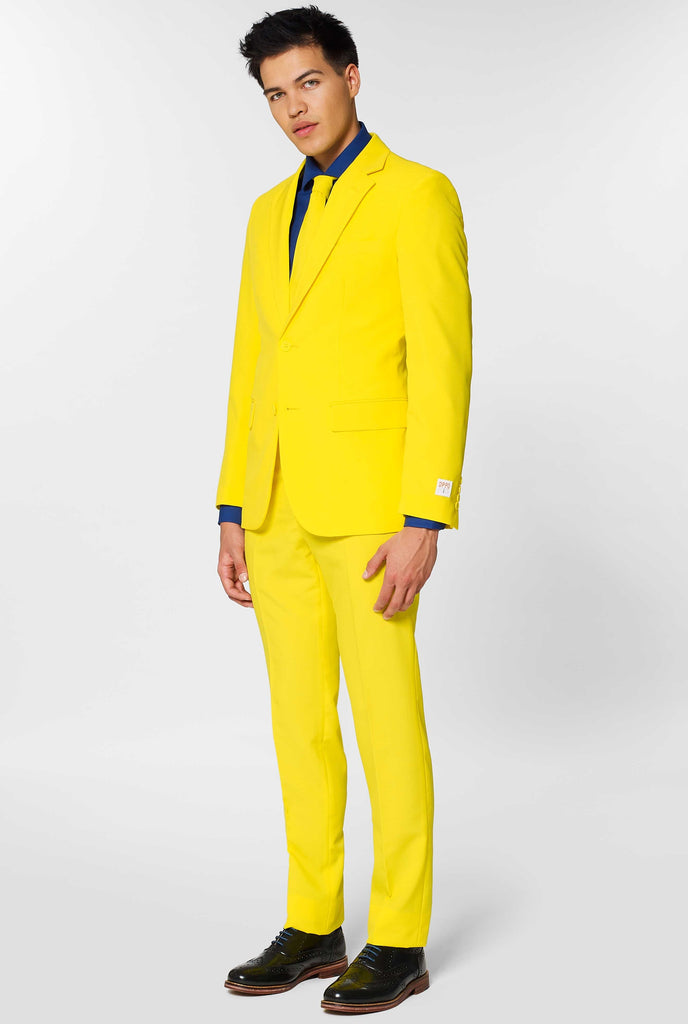 Man wearing yellow men's suit and dark blue dress shirt