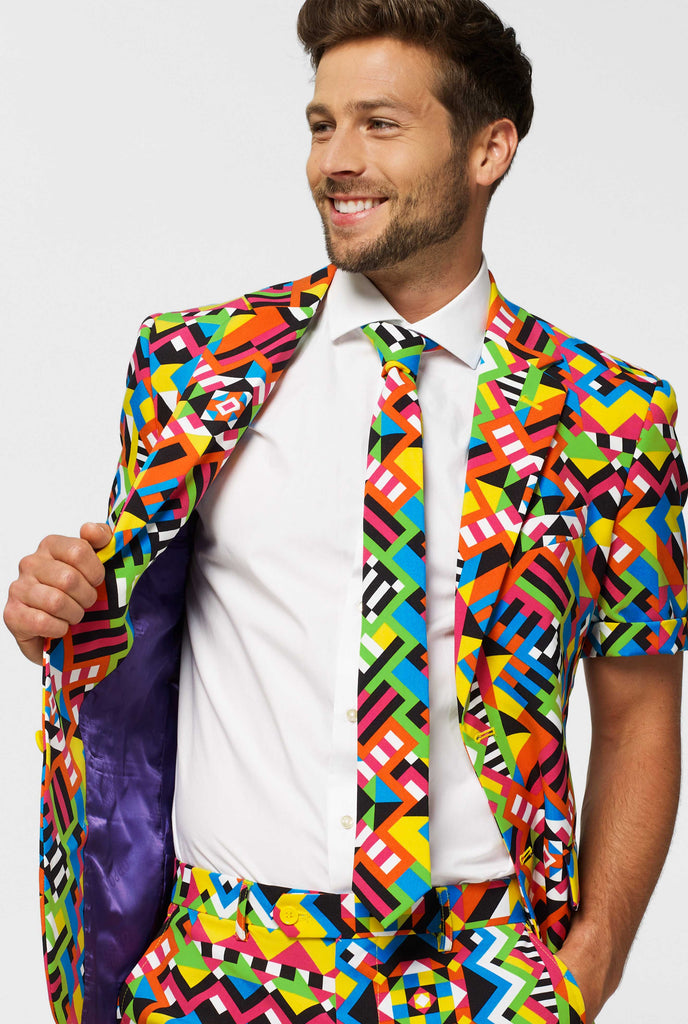 Man wearing colorful summer suit, consisting of short, jacket and tie