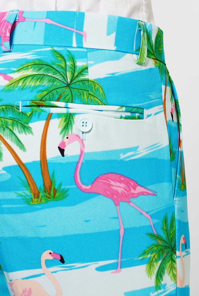 Man wearing summer suit with tropical flamingo print, close up of pants