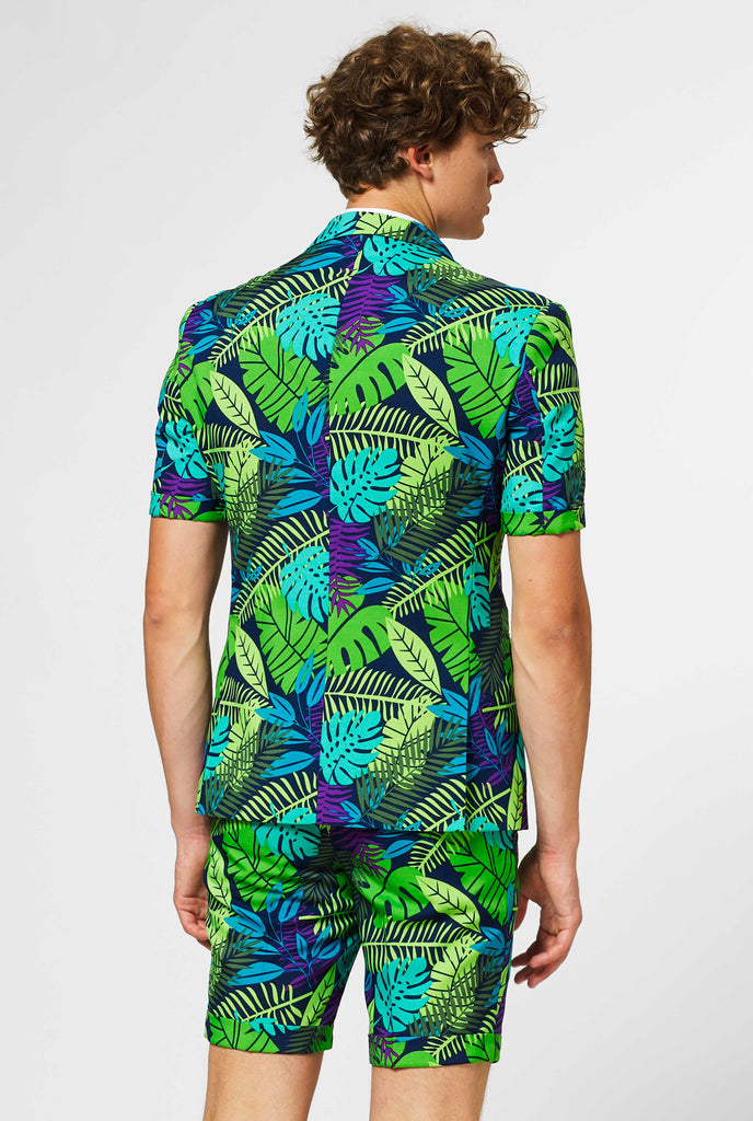 Man wearing green summer suit with jungle leaf print, view from the back