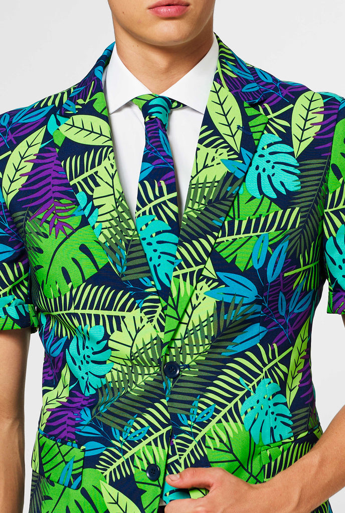 Man wearing green summer suit with jungle leaf print, close up