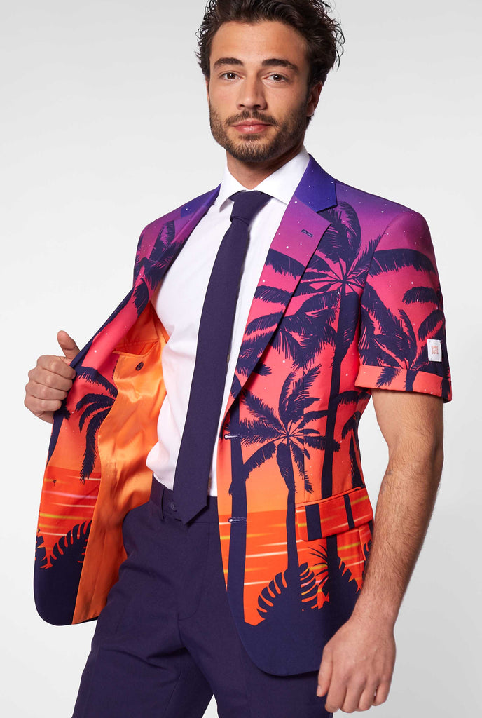 Man wearing summer suit with palms and sunset print