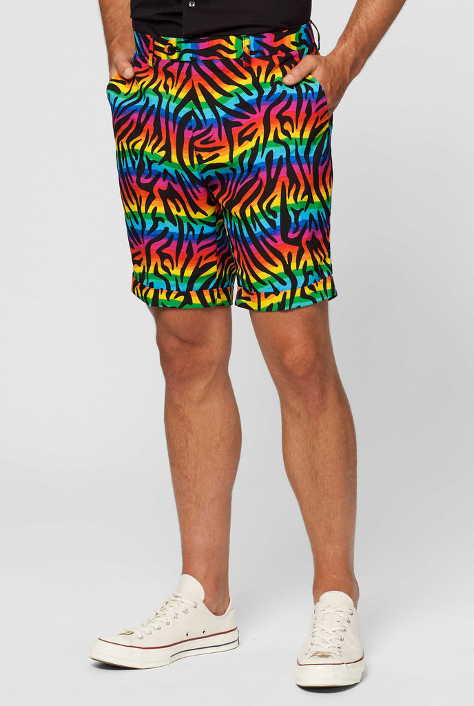 Man wearing summer suit with rainbow zebra stripes print, close up of pants