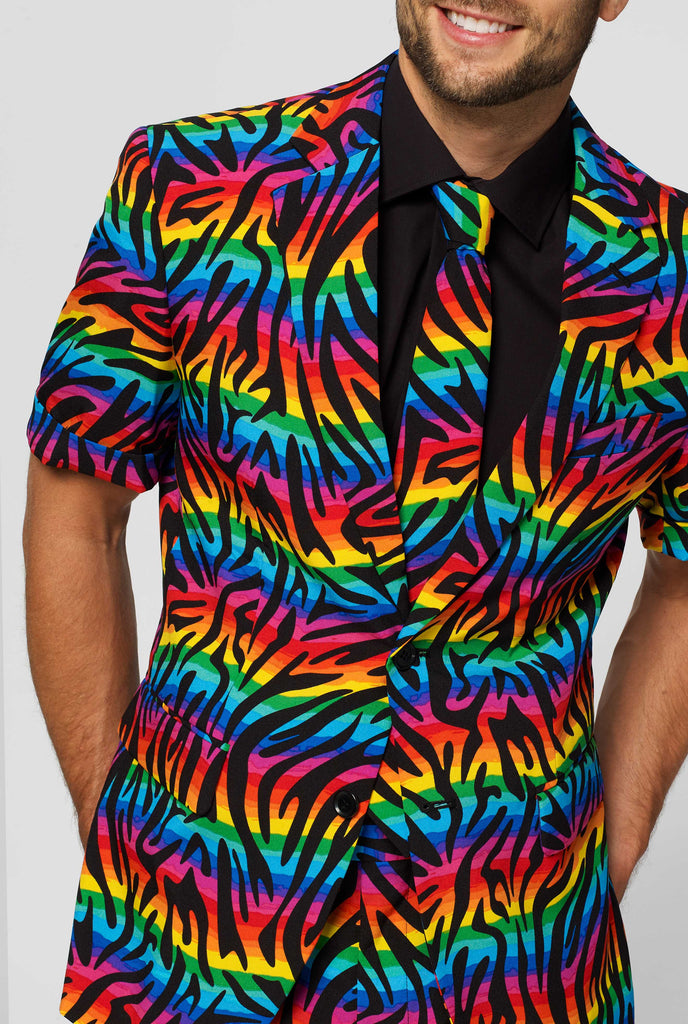 Man wearing summer suit with rainbow zebra stripes print, close up