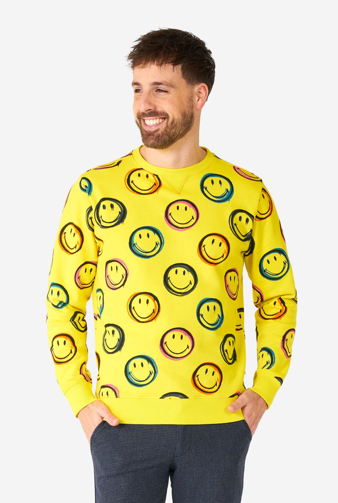 Man wearing yellow men's sweater with Smiley print