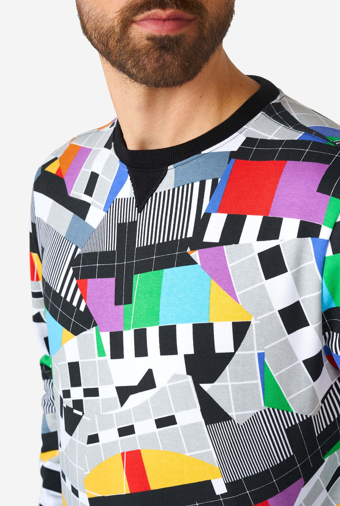 Man wearing retro TV-testscreen multi-color sweater, close up