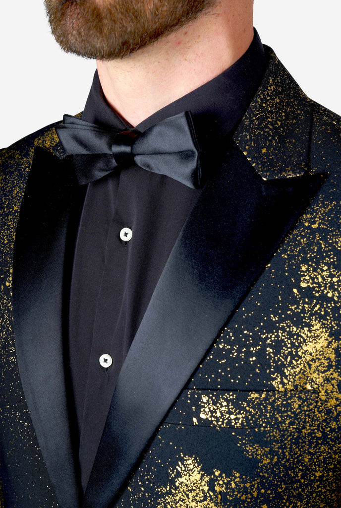 Man wearing black blazer with golden Christmas tree print, close up