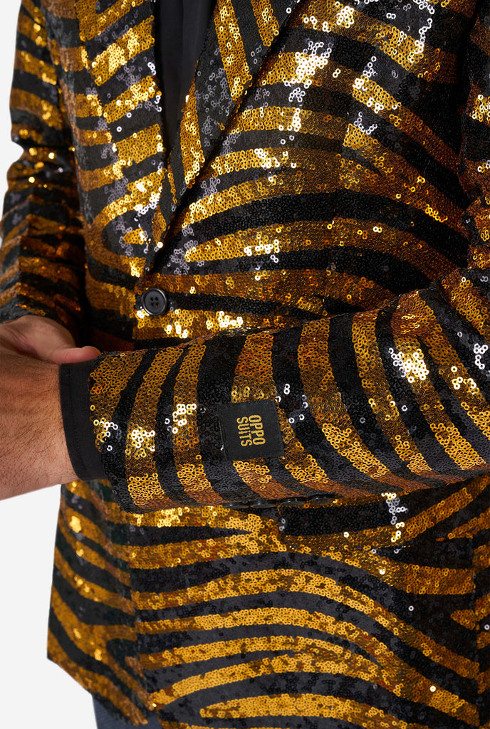 Man wearing black and gold sequins tiger stripe blazer, close up