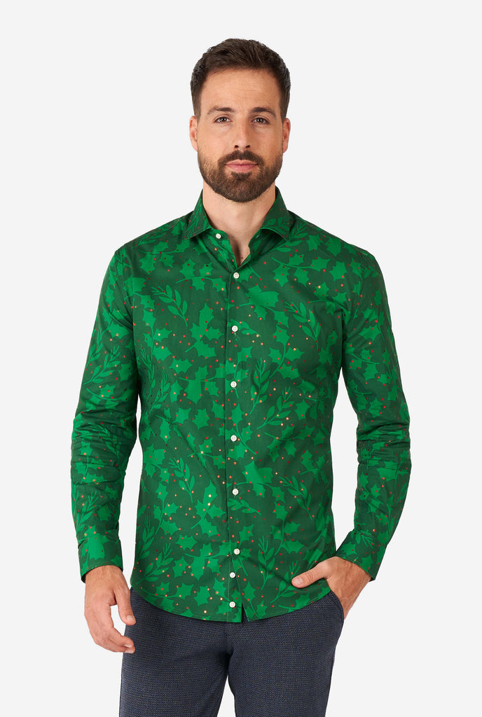 Man wearing green Christmas dress shirt with holly and mistletoe print