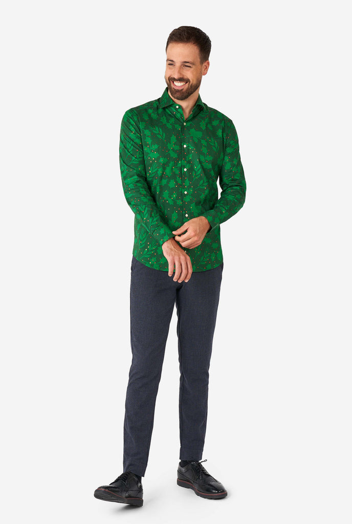 Man wearing green Christmas dress shirt with holly and mistletoe print