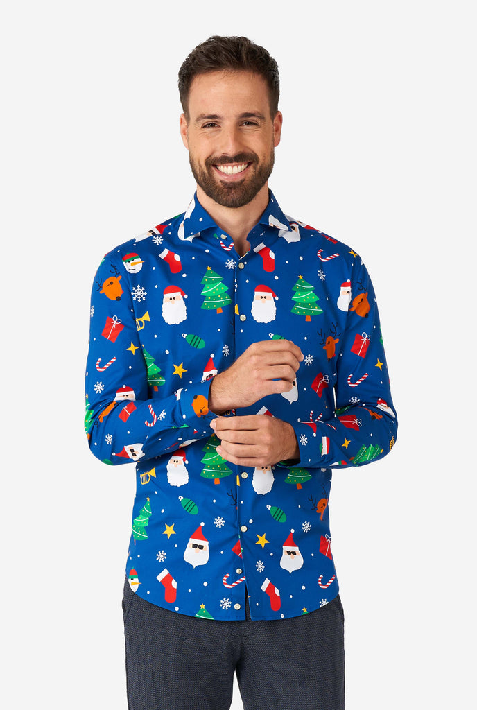 Man wearing blue Christmas dress shirt with Christmas icons